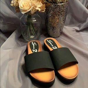 Seven black sandals